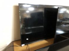A Samsung 40" LCD TV (wall mounted no stand)
