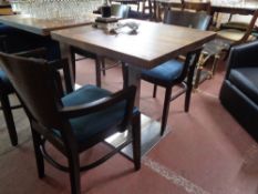A cafe table together with a pair of chairs