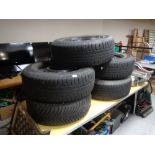 Five car tyres on metal rims