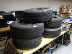 Five car tyres on metal rims