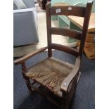 A Victorian elm child's rocking chair