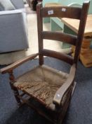 A Victorian elm child's rocking chair