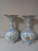 A pair of 20th century floral patterned enamel vases,