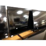 A Samsung 40" LCD TV (wall mounted no stand) and remote