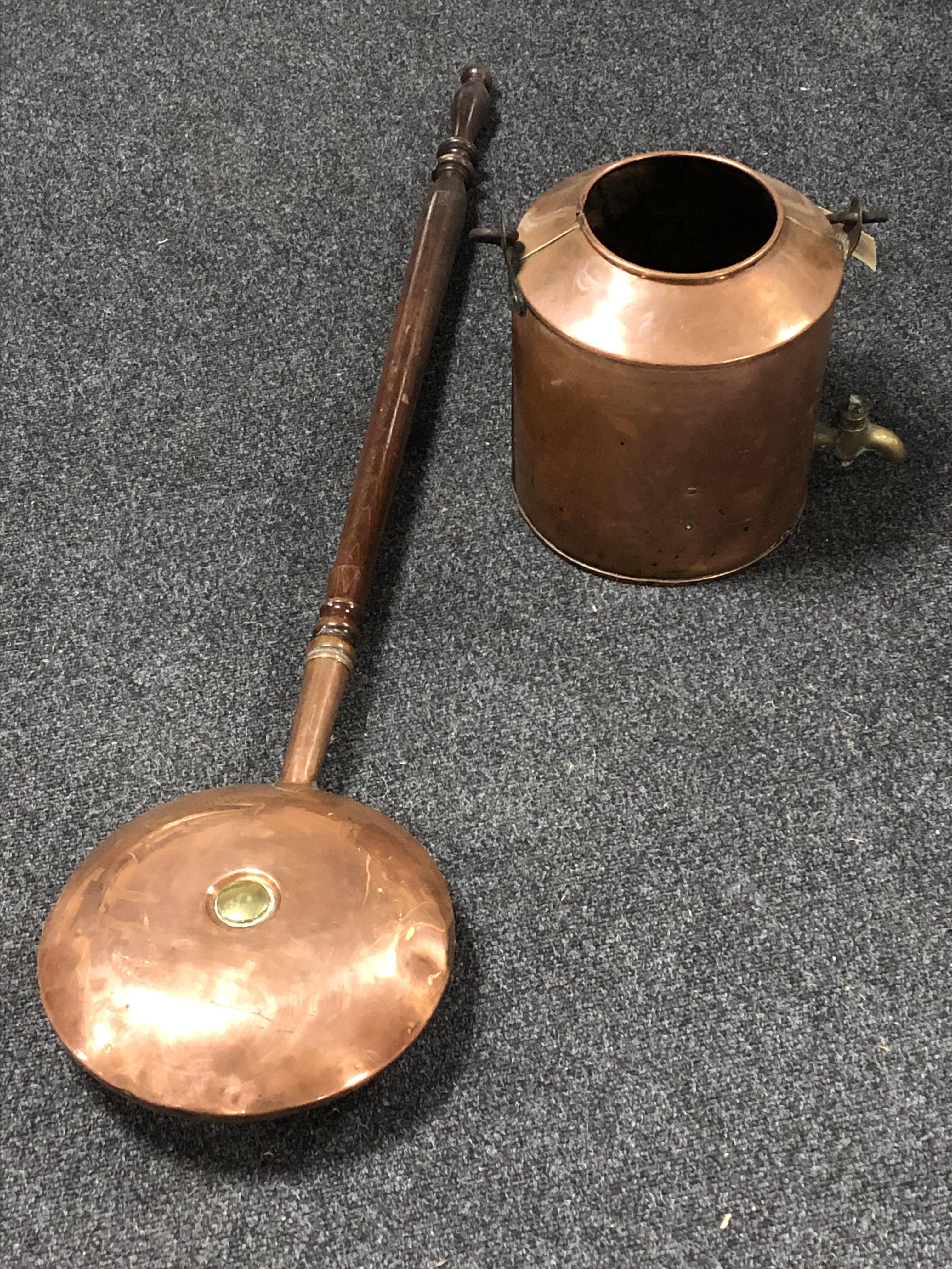 An antique copper urn with tap and a bed warming pan