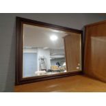 A contemporary bevelled wall mirror CONDITION REPORT: 88cm by 63cm.