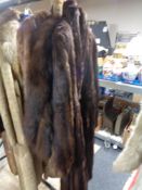 A fur wrap and a two fur coats