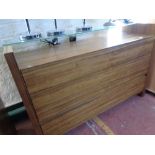 A three drawer contemporary chest with glass shelf