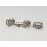 Four silver dress rings
