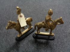 A pair of antique brass and cast iron door stops