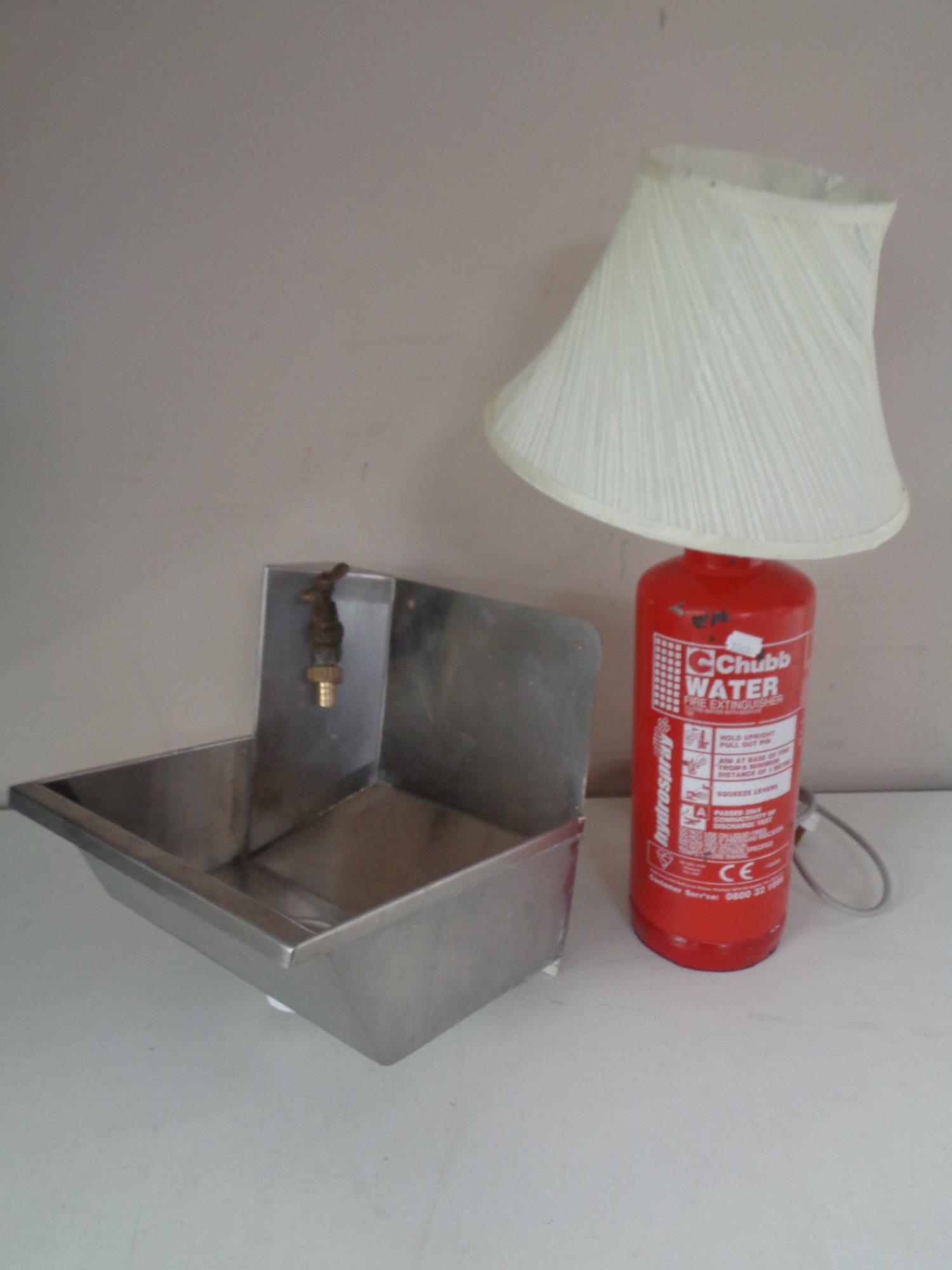 A table lamp made from a Chubb fire extinguisher together with a stainless steel hand sink