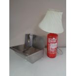 A table lamp made from a Chubb fire extinguisher together with a stainless steel hand sink