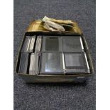 A tin of glass photographic slides