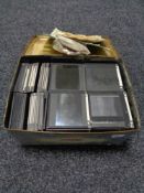 A tin of glass photographic slides
