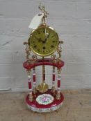 An Italian china and brass mantel clock with pendulum