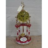 An Italian china and brass mantel clock with pendulum