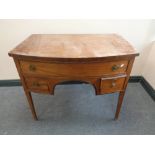 A George III mahogany D-shaped chest fitted three drawers with lion mask handles