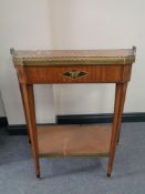 A 19th century inlaid shaped two tier side table with brass gallery