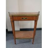 A 19th century inlaid shaped two tier side table with brass gallery