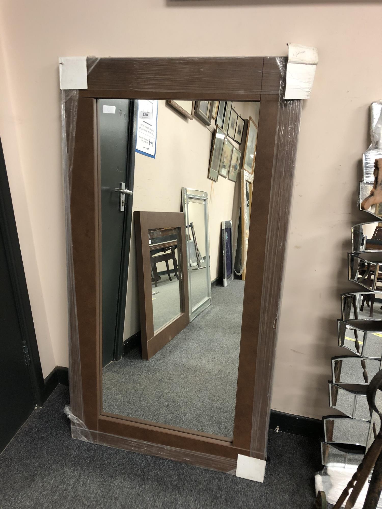 A brown contemporary flat framed mirror