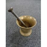 An antique brass pestle and mortar