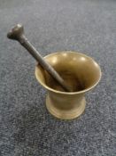 An antique brass pestle and mortar