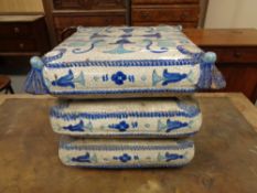 A 19th century faience glazed terracotta stool in the form of three cushions