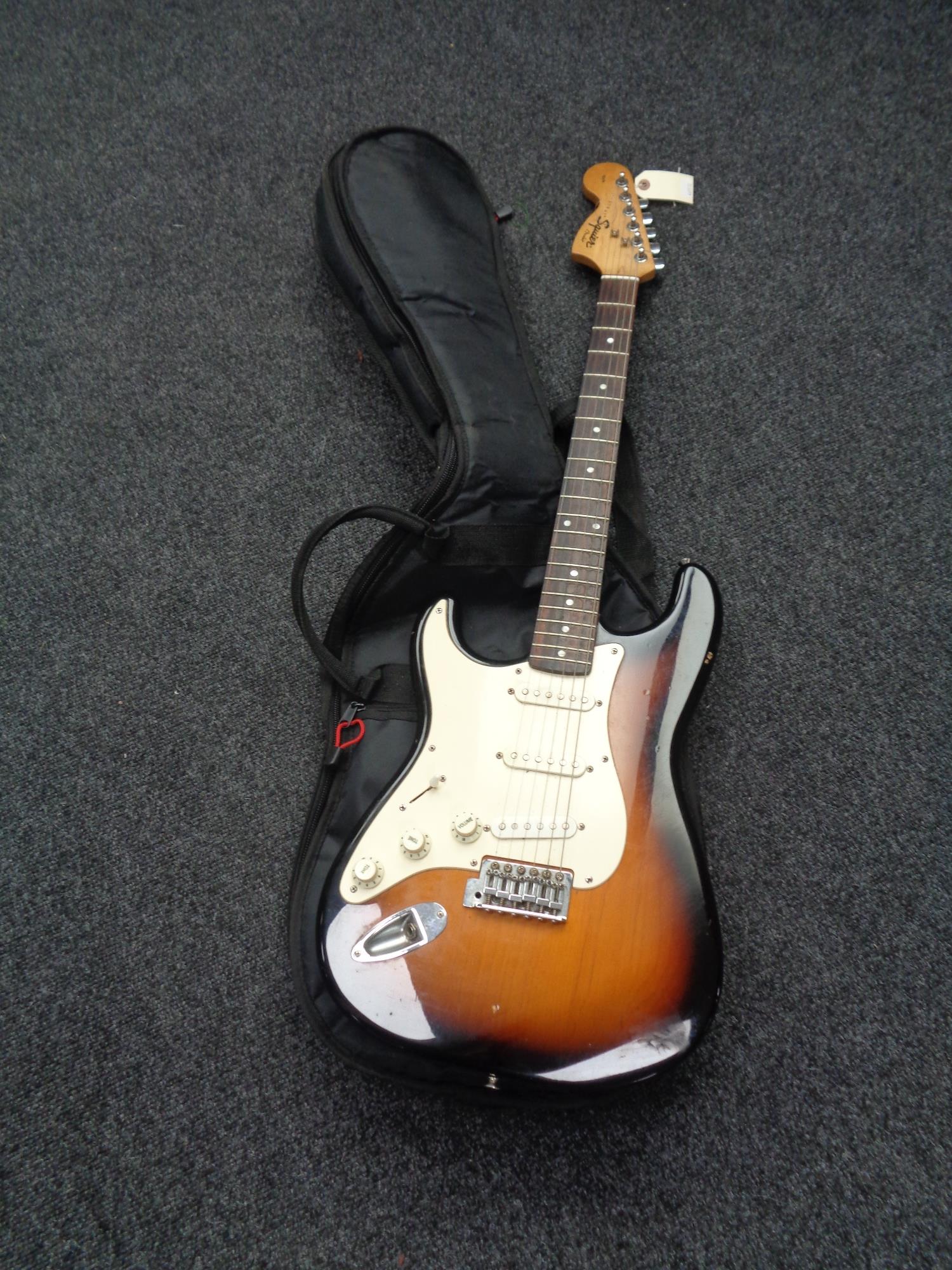 A Fender Squire Stratocaster left-handed electric guitar in carry bag