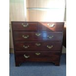 A George III mahogany five drawer chest with brass drop handles on bracket feet