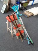 A set of mid century painted stool steps together with two bundles of walking sticks,