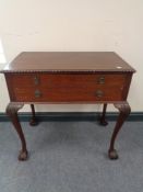 A Victorian mahogany two drawer cutlery table on cabriole legs on claw and ball feet