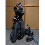A Vogue golf bag containing Vogue drivers and irons plus a folding golf trolley