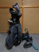 A Vogue golf bag containing Vogue drivers and irons plus a folding golf trolley