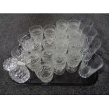 A tray of assorted drinking glasses and a lead crystal liqueur decanter