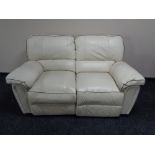 A cream leather two seater reclining settee