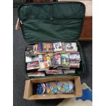 A luggage case and box of CD's and DVD's