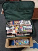 A luggage case and box of CD's and DVD's