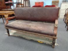 A Victorian pine framed hall settee upholstered in brown leather CONDITION REPORT: