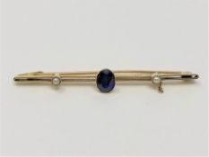 A 15ct gold brooch set with a sapphire, 2.9g.