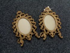 A pair of early twentieth century ornate brass photograph frames