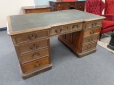 A Victorian oak twin pedestal partner's desk fitted nine drawers on both sides,