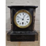 A Victorian black slate mantel clock with enamelled dial