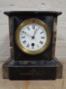 A Victorian black slate mantel clock with enamelled dial