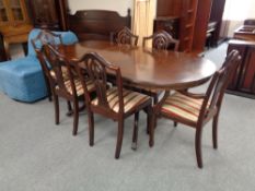 A Regency style twin pedestal dining table and six Hepplewhite style chairs