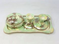 A Maling lustre "Golden Spray" pattern four-piece trinket set comprising a lidded powder bowl,