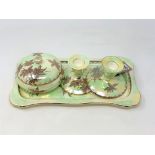 A Maling lustre "Golden Spray" pattern four-piece trinket set comprising a lidded powder bowl,