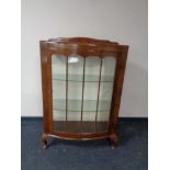 A mid 20th century walnut bow-fronted display cabinet