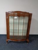 A mid 20th century walnut bow-fronted display cabinet
