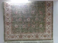 A floral rug on green ground CONDITION REPORT: Approximately 245cm by 156cm.