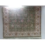 A floral rug on green ground CONDITION REPORT: Approximately 245cm by 156cm.